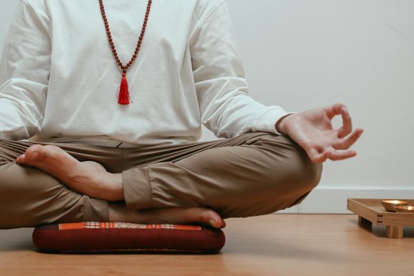 Close-up of a person's hands in a Gyan Mudra pose during meditation.